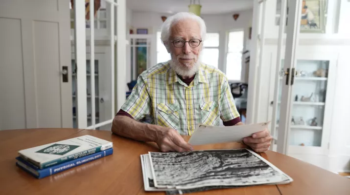 Paul F Hoffman sitting at his desk